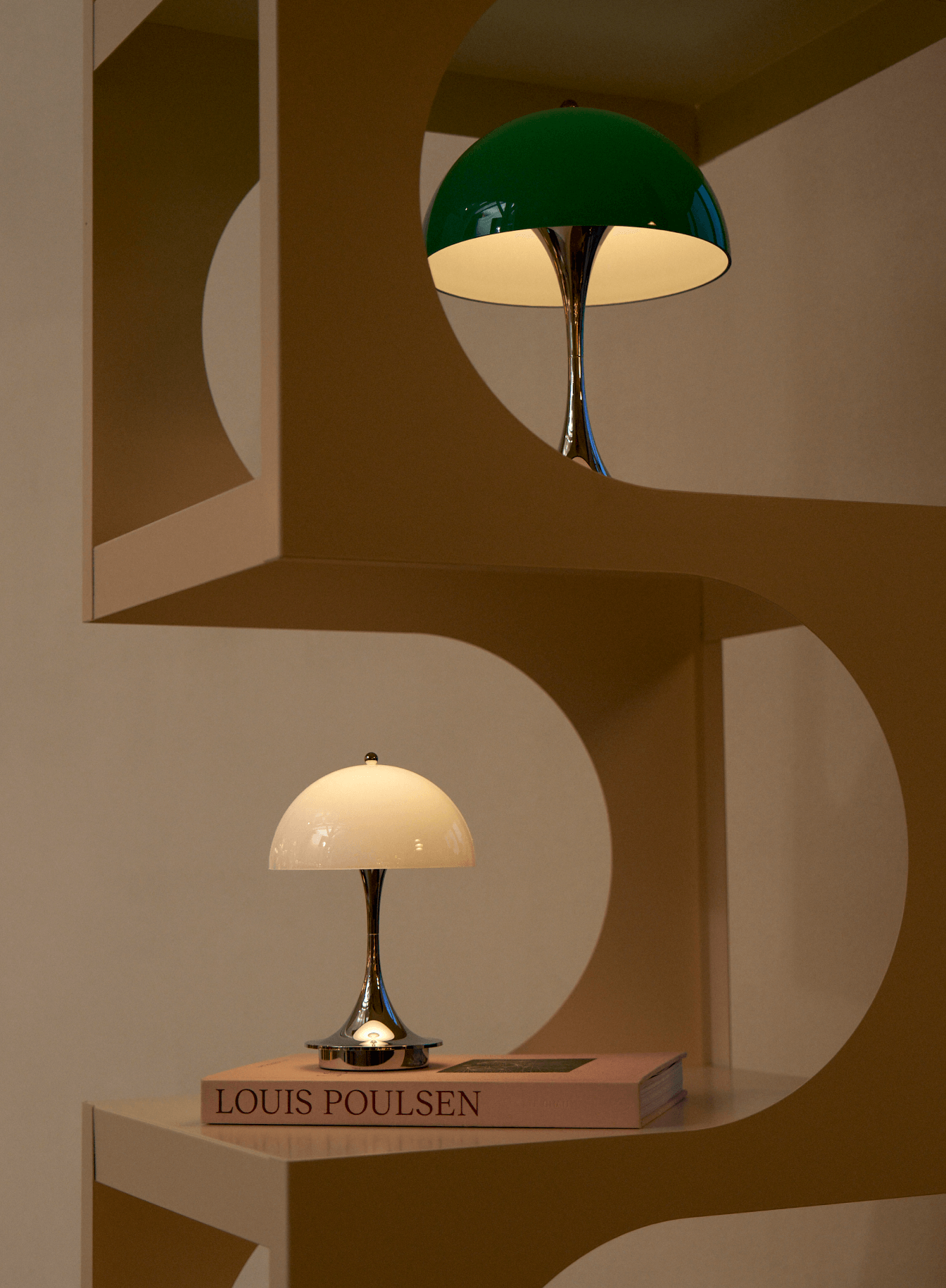 Panthella table lamp on Louis Poulsen book in showroom display, © 2025 Louis Poulsen.