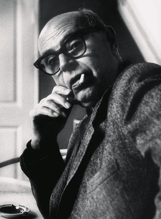 Portrait of Poul Henningsen seated in soft light, © 2025 Louis Poulsen.